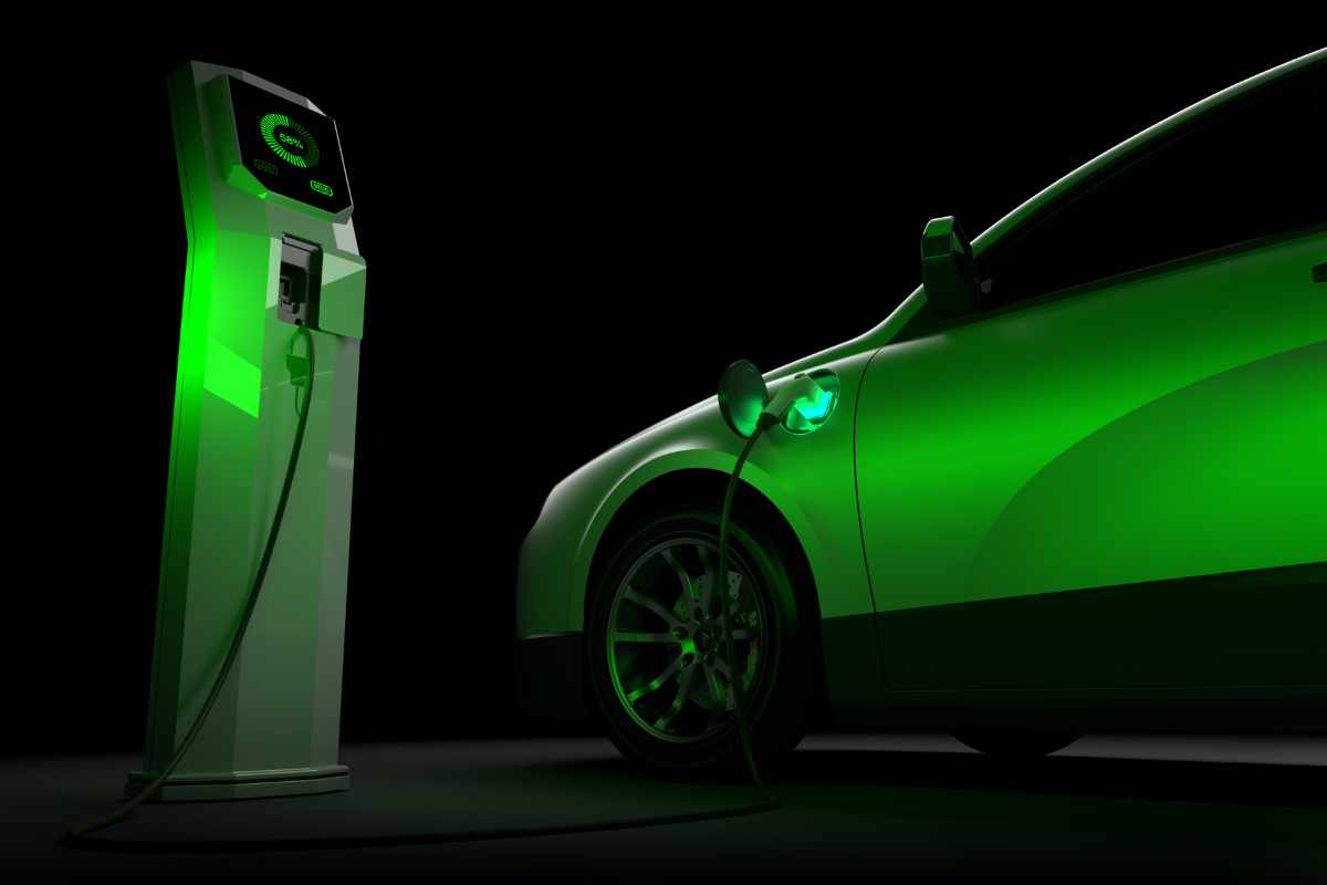 A black and green image of a car and EV charger, illustrating the growth of electric vehicles