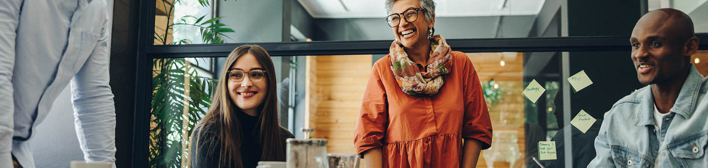 Happy workers in a meeting in modern glass office