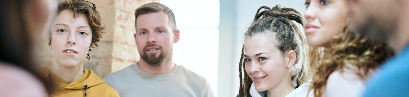 Several employees dressed in casual clothing having a meeting about energy tips for employees