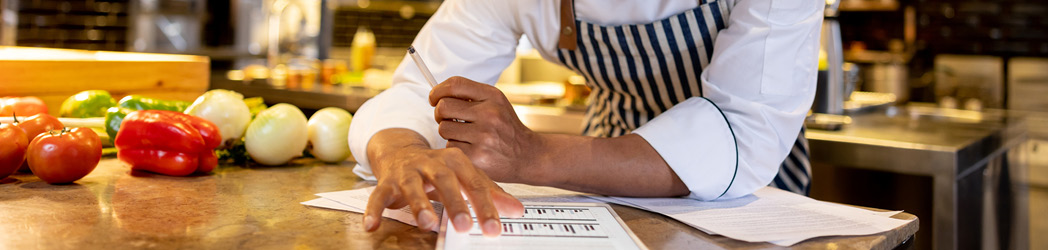 restaurant owner checking business energy usage and business energy strategy through smart meter on ipad