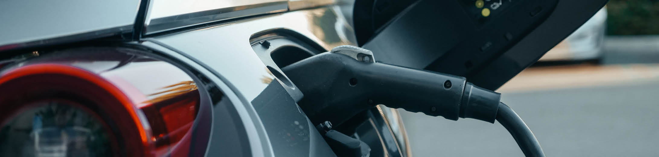 Image of an electric vehicle with charger plugged in