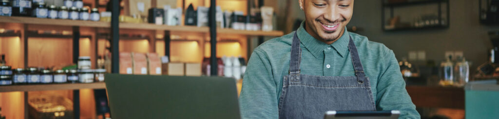 business owner using laptop and tablet