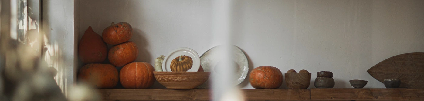 Pumpkins on a shop shelf as part of a halloween display