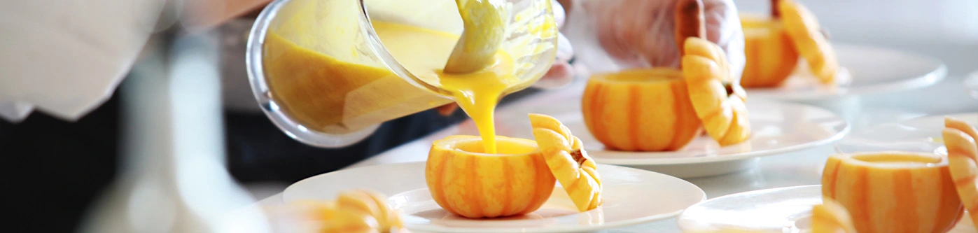 Pumpkin soup served in pumpkin bowls