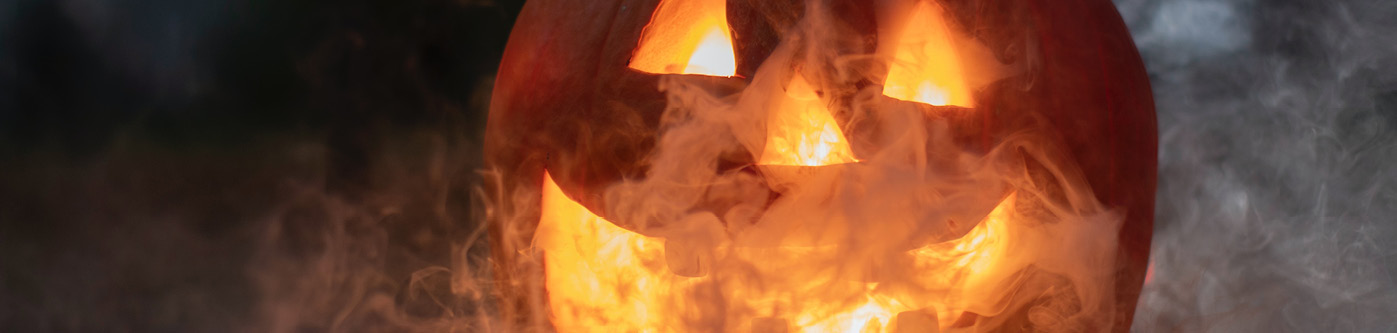 A pumpkin filled with smoke against a dark background, advertising halloween marketing ideas