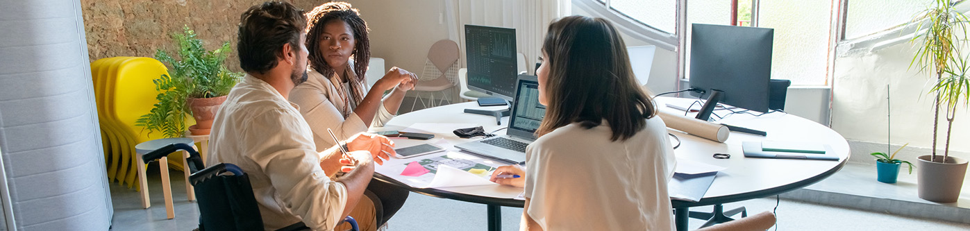 Office Energy Saving Tips - a group of colleagues in the office discussing their energy usage