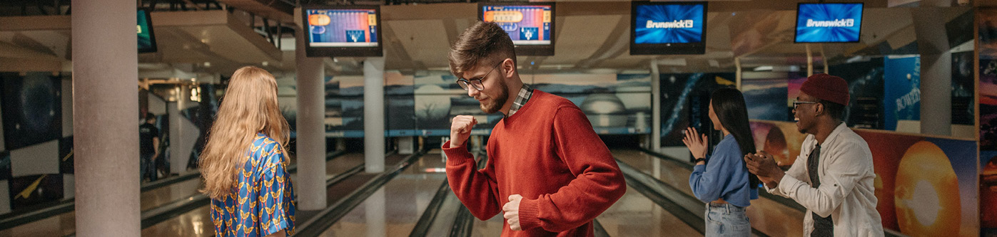 happy people in a bowling alley. How can leisure businesses reduce their energy consumption
