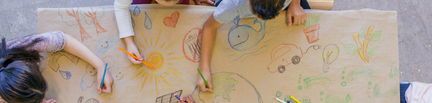 school children making an energy efficiency poster for their school