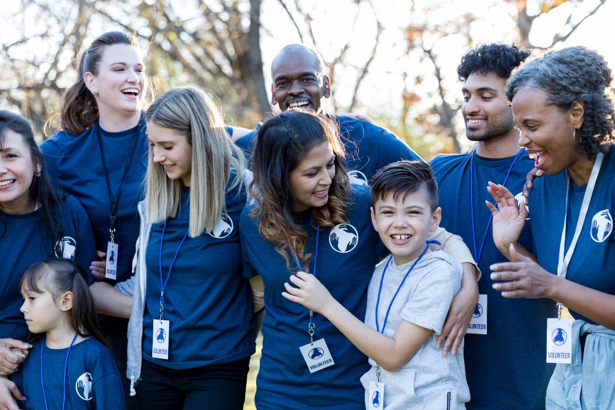 the importance of social responsibility for businesses shown with employees in blue tshirts volunteering for a childrens charity