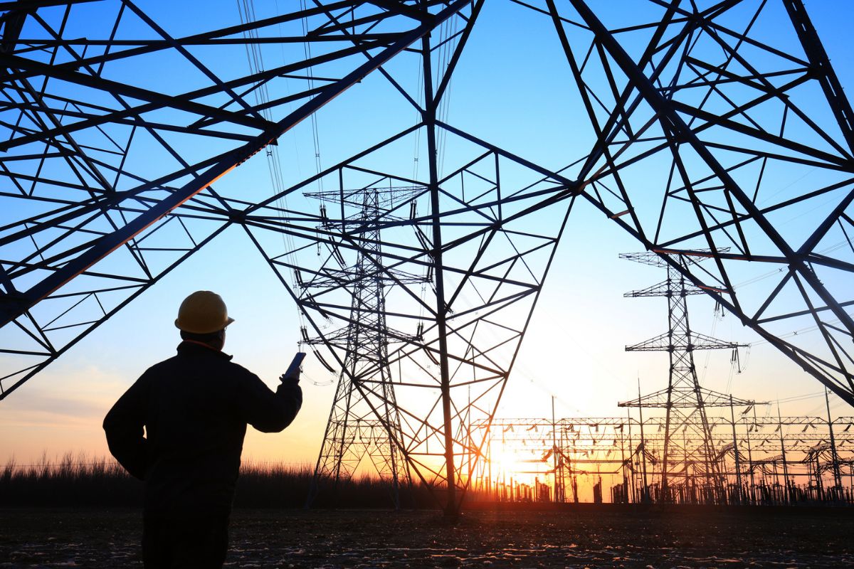 electrical engineer standing in front of a pylon